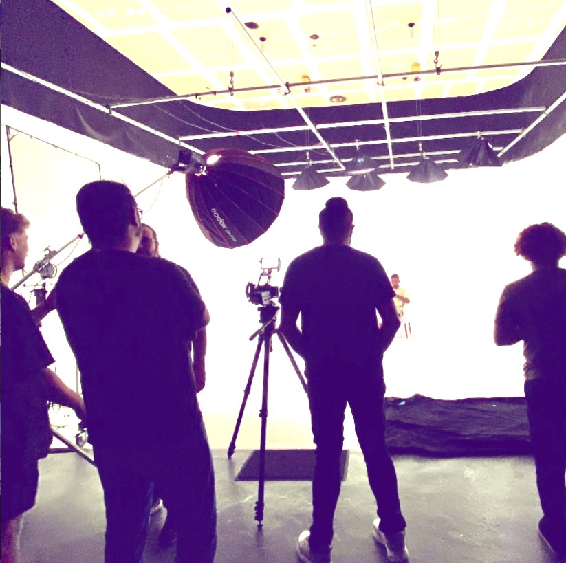 Film set with lighting rig during an audiovisual shoot.